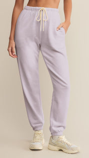 Light purple sweatpants with a cream drawstring.