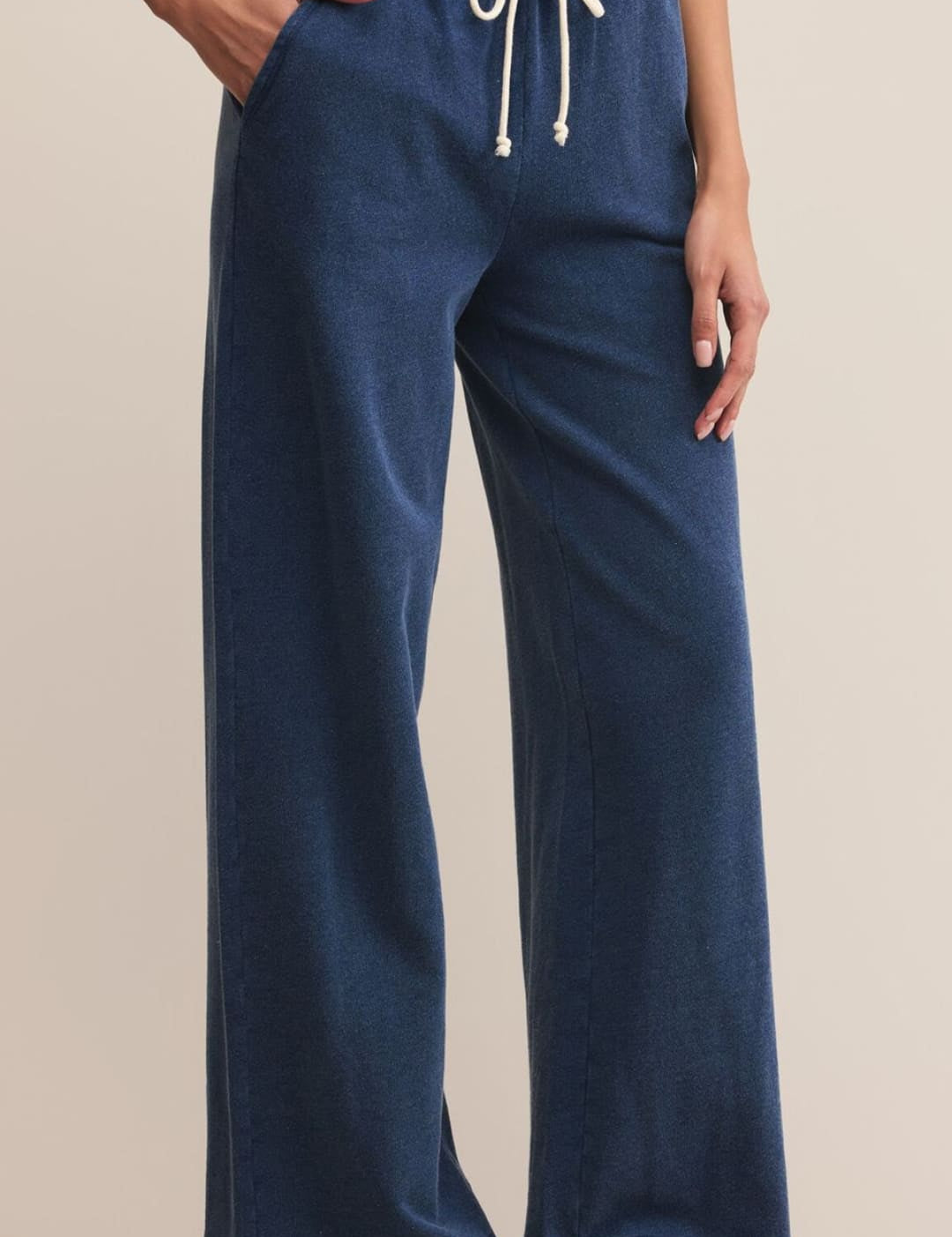 Navy blue wide-leg sweatpants with an elastic waistband and white drawstring.