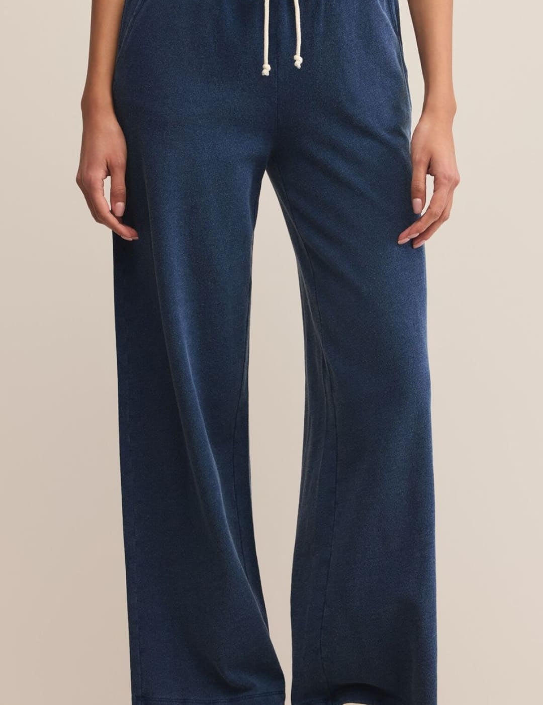 Navy blue wide-leg sweatpants with a white drawstring.