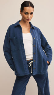 A woman in a blue shacket and matching sweatpants.