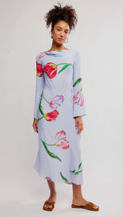 A light blue long-sleeved midi dress featuring a vibrant tulip print with red, pink, and green flowers.
