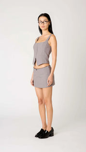 Light gray sleeveless top and mini skirt set with black trim.