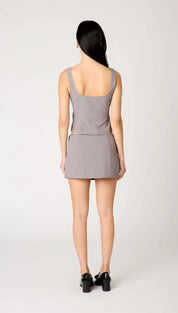 A woman’s sleeveless, square-neck top and mini skirt in a matching gray color.